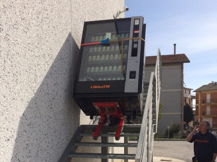 Transporting a vending machine up an outdoor stairs with a stair climbing dolly