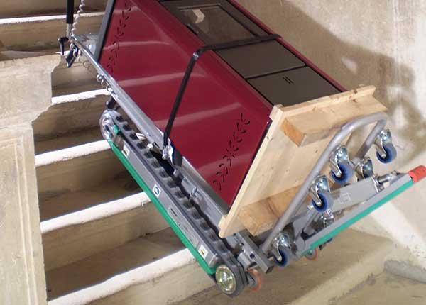 Transporting a boiler up stairs with electric stair climbing hand cart