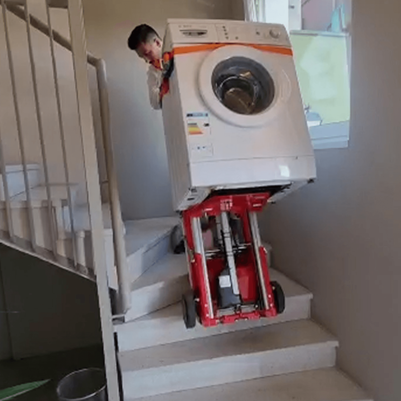 One person can easily transport a washing machine up stairs with the electric stair climber Buddy Lift