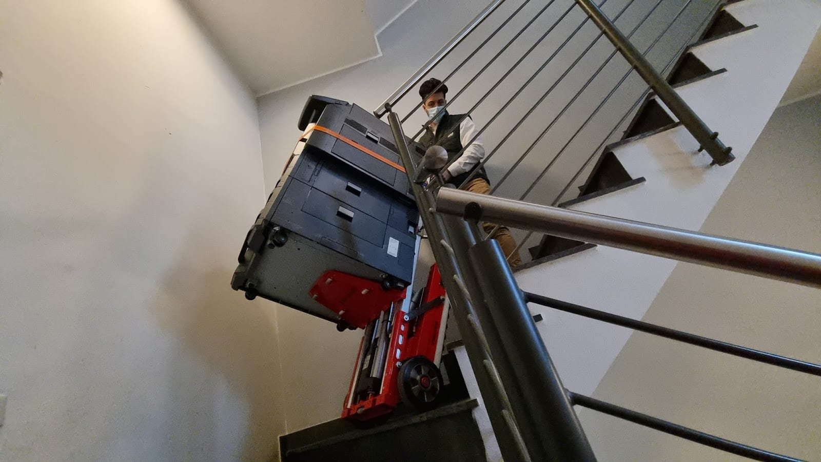 One person can easily transport a photocopier up stairs with the powered stair climber Buddy Lift